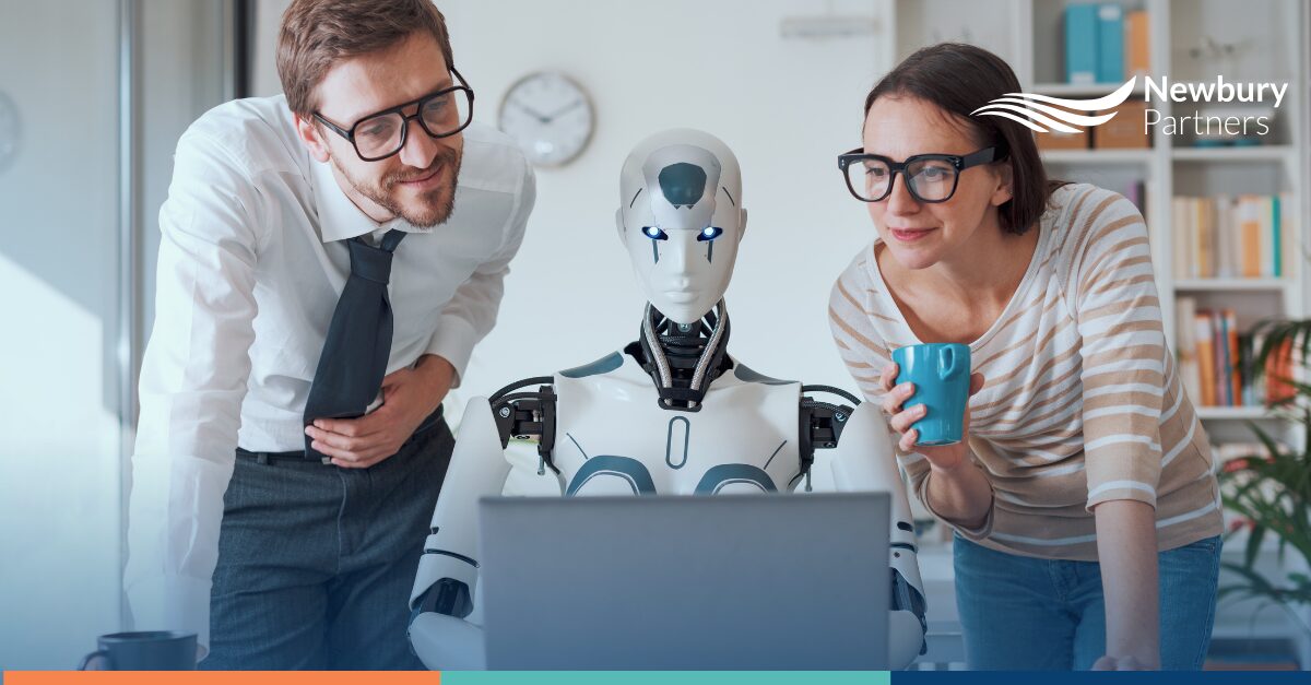 Business professionals working with humanoid robot at laptop representing AI agents in staffing industry.
