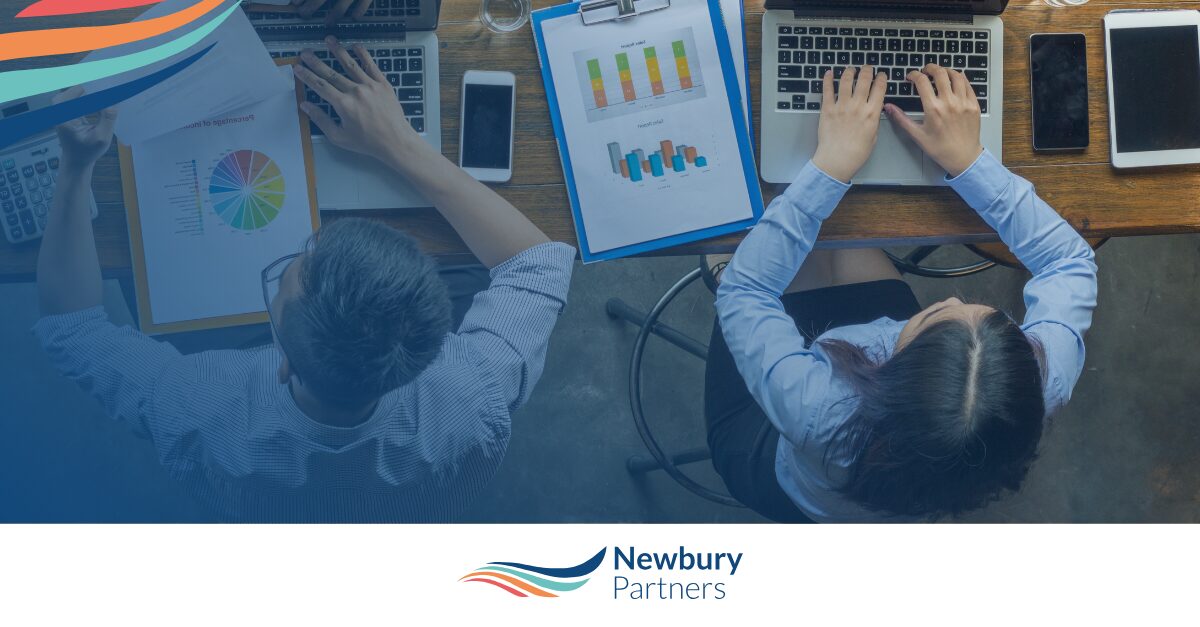 Business professionals analyzing financial charts and data for staffing margin improvement strategies.