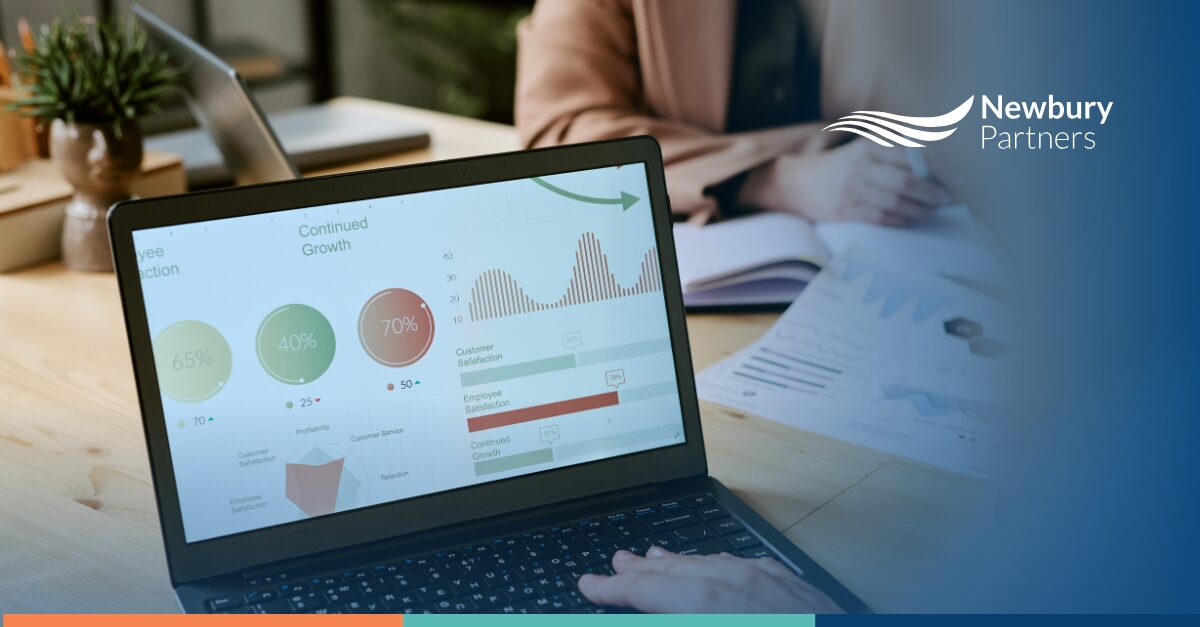 Laptop displaying business analytics dashboard during staffing firm data audit review process.