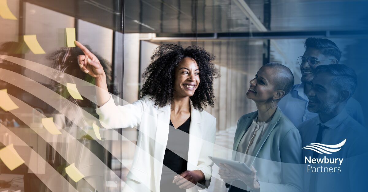 Professional demonstrating AI leadership staffing through collaborative strategic planning with team.