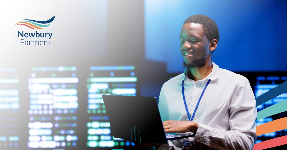 Professional evaluating staffing tech partner solutions on laptop in data-driven office environment.