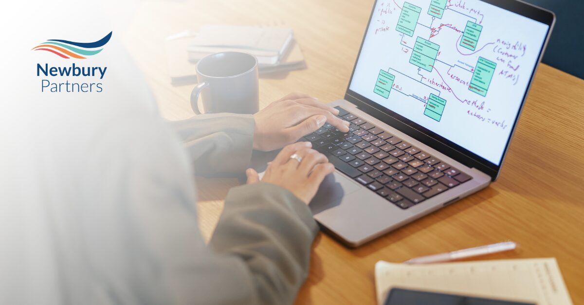 Staffing professional reviewing CRM system on laptop to improve staffing systems reset in their firm.