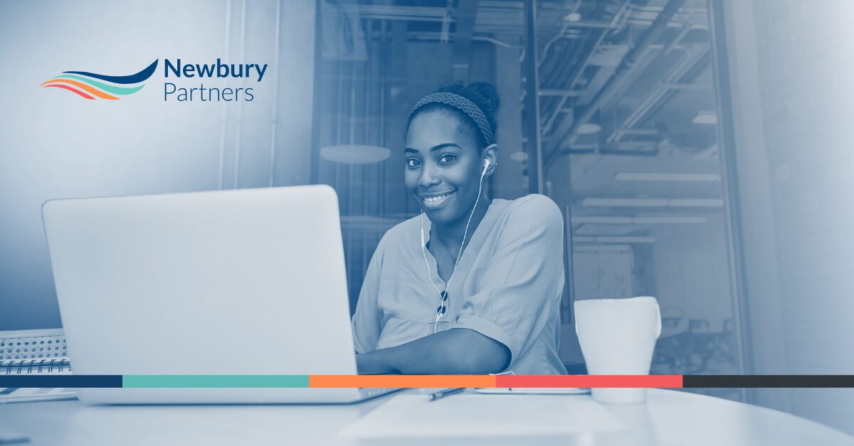 Staffing professional reviewing Bullhorn commission visibility data on a laptop.